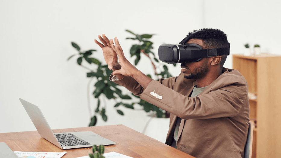 Man using virtual reality headset while interacting with augmented reality interface