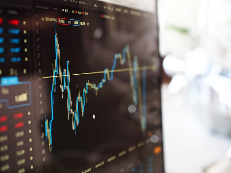 Stock market trading charts displayed on a computer screen showing financial data trends